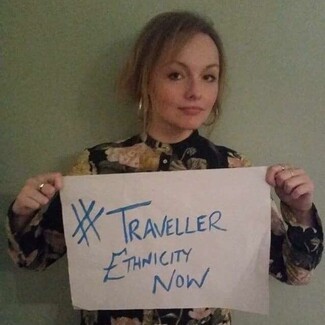 Amy Ward holding up #Traveller Ethnicity Now Campaign 