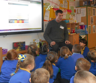 Thomas McCarthy performing for children at a school