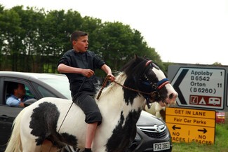 Appleby Horse Fair boy on horse youth gypsy cobb road sign