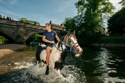 Boy on horse in River at Appleby