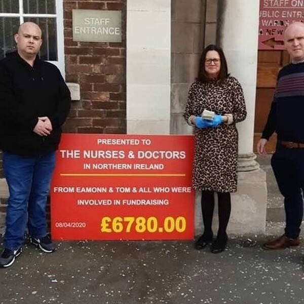 travellers outside a hospital raising money