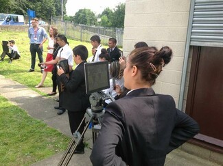 Young people in school uniform filming