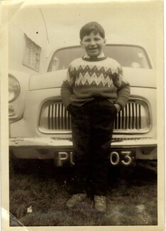Chris Smith stops in front of a car smartly dressed ready for school 