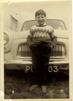Chris Smith stops in front of a car smartly dressed ready for school