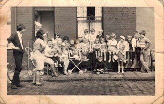 Jake Nicholson stood next to his sister Cathrine Cunningham (Amanda Reed’s Mum). Sat down Margaret Fensome and Margaret Edeson. Diane Shann stood at back. Dot Daley stood in doorway. Doreen Waite with Darren Cunningham on her knee, unknown.