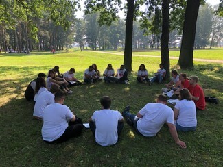 Young people sat in circle reflecting 