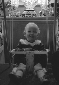 Baby girl on swing. 1971. Barnsley. South Yorkshire. © KIERON FARROW
