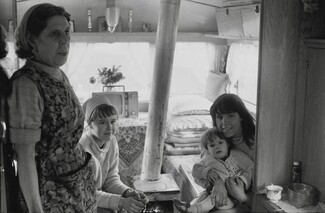 Grandmother with two daughters and granddaughter. Travellers. Inside caravan with stove. 1971. Barnsley. South Yorkshire. © KIERON FARROW.