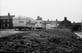 Travellers trailers on waste ground recently cleared of terrace houses. Early 1971. Barnsley. South Yorkshire. © KIERON FARROW.