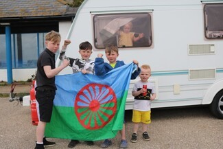Children and a Romani Flag