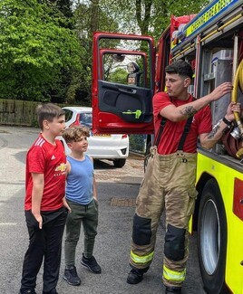 Lawrence Ward with his two nephews (l-r) Martin Ward and Michael Ward at an open community day at his fire station in Cheshire