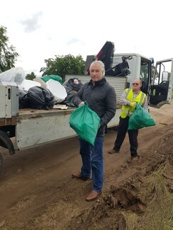 Lead photograph: Billy Welch and brother-in-law Henry taking part in the clean-up operation