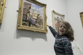 Georgie's Son Ted points to one of the paintings