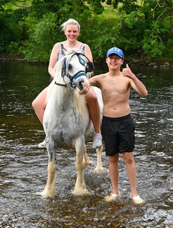 Horses and people in the river