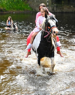 Horses and people in the river