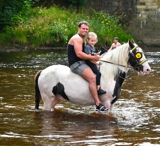 Horses and people in the river